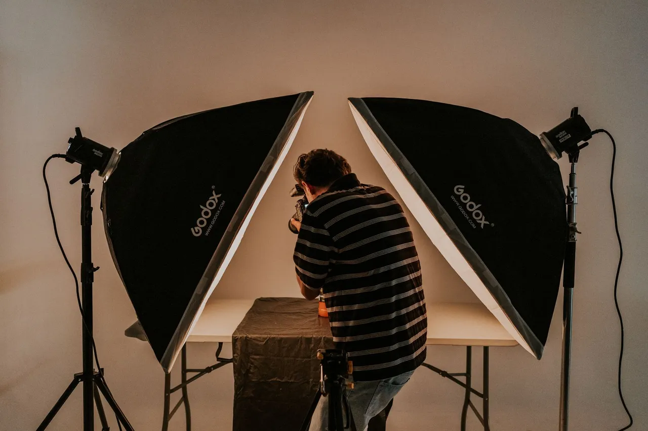 Photographer working in a studio with softbox lighting equipment.