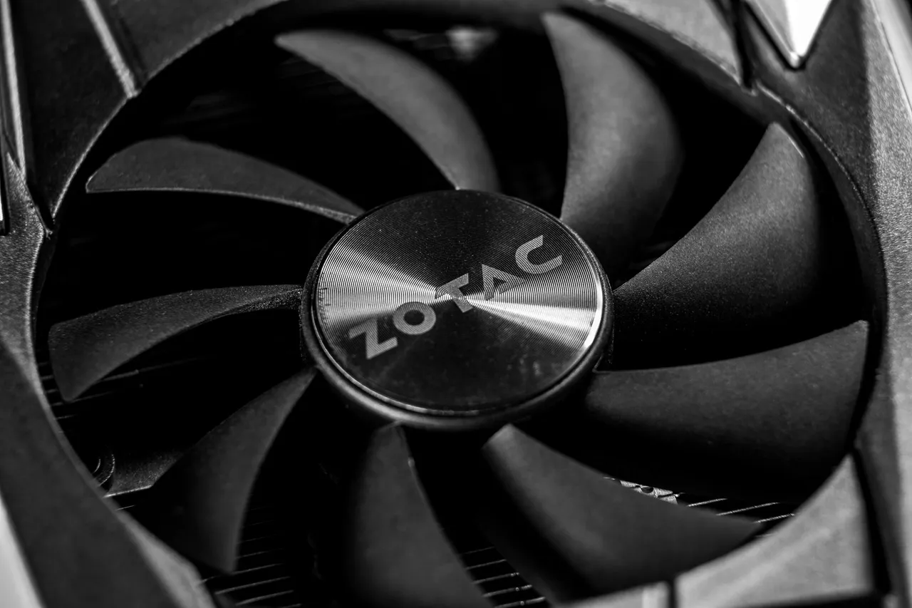 Detailed black and white shot of a computer graphics card cooling fan.
