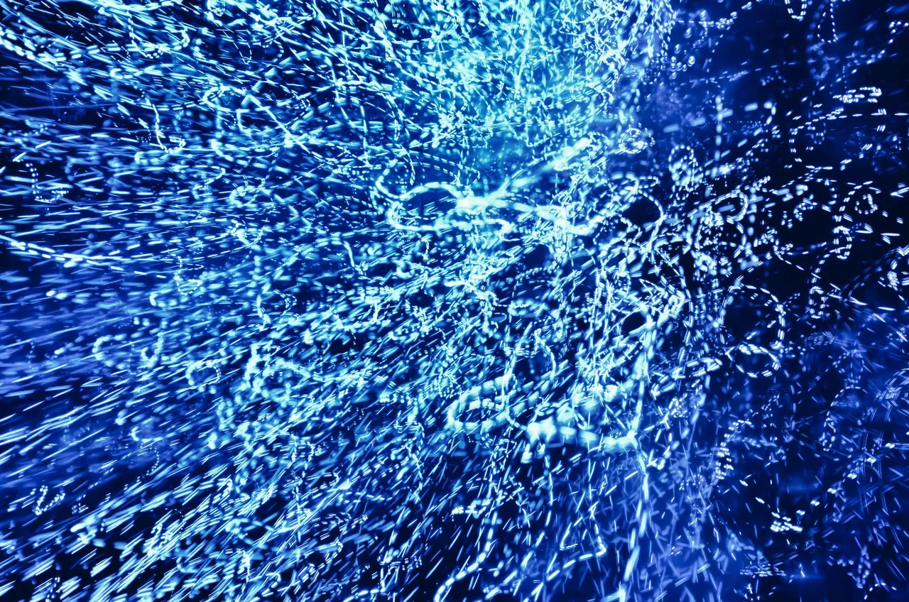 Vivid abstract image of dynamic blue light patterns creating a captivating visual effect.